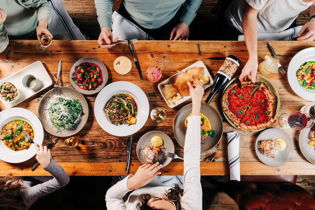 Family-style dinner at Stone House Nevada City — wood-fired pizza, seasonal salads, and house-made pasta
