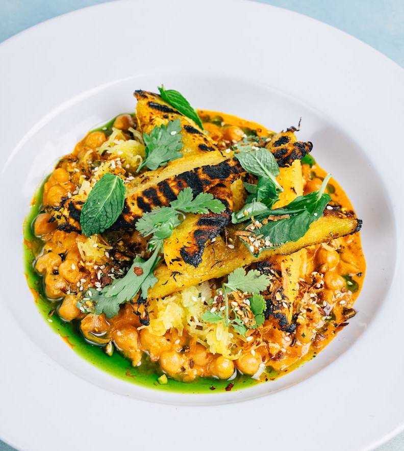 Grilled plantain and chickpea plant-forward plate at Stone House catering