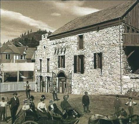 Historic archive photograph of Stone House Nevada City exterior with horse-drawn carriage