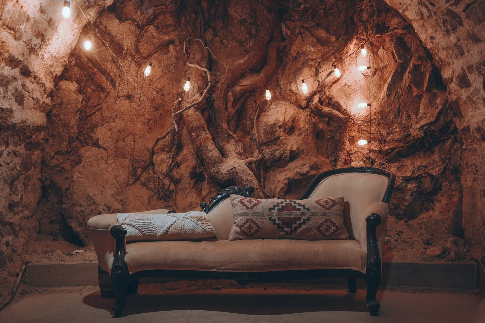 Cocktail service in The Cavern at Stone House Nevada City — underground stone walls and candlelit ambiance