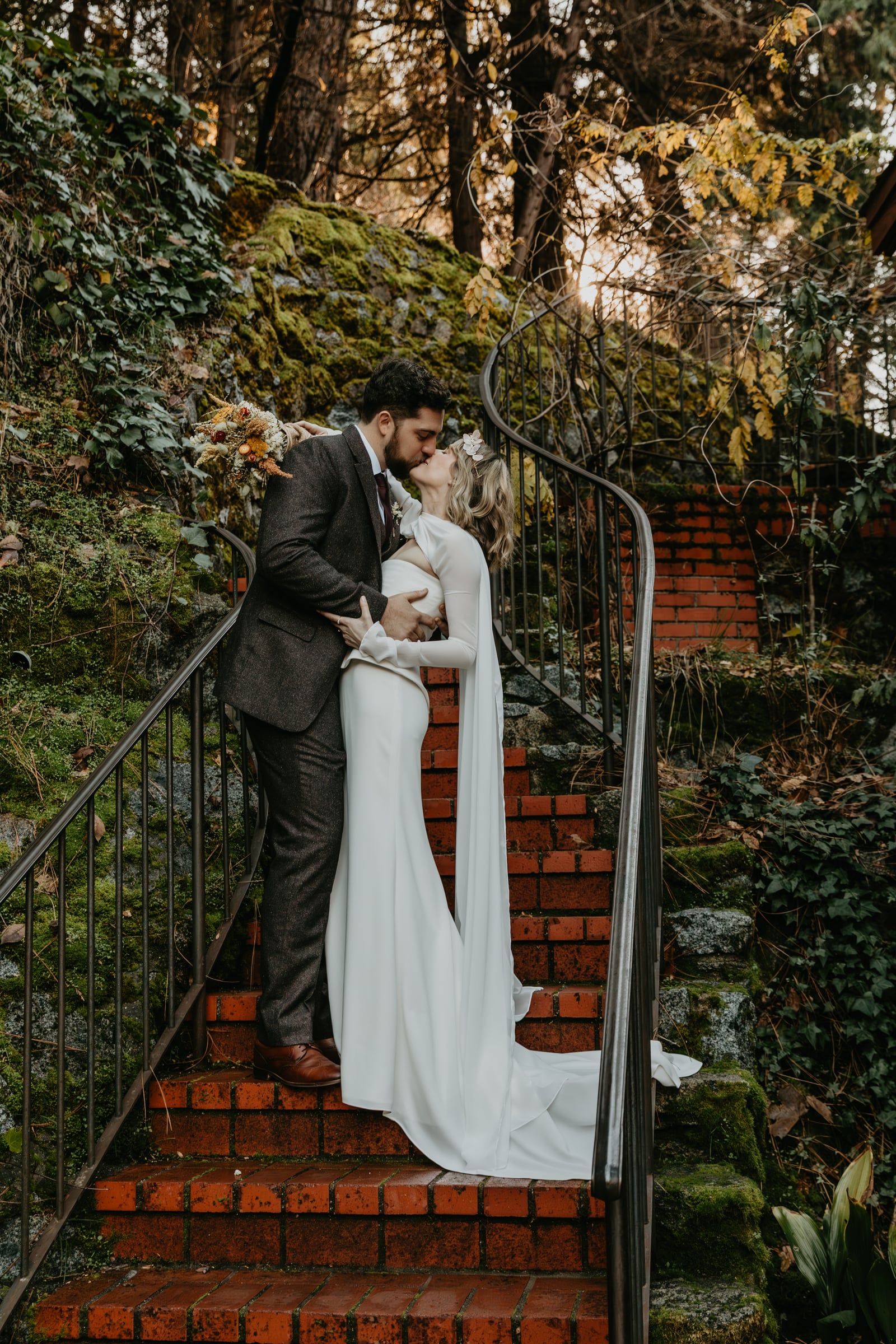 Wedding bride portrait in The Courtyard at Stone House Nevada City — outdoor stone-walled venue framed by historic 1857 architecture