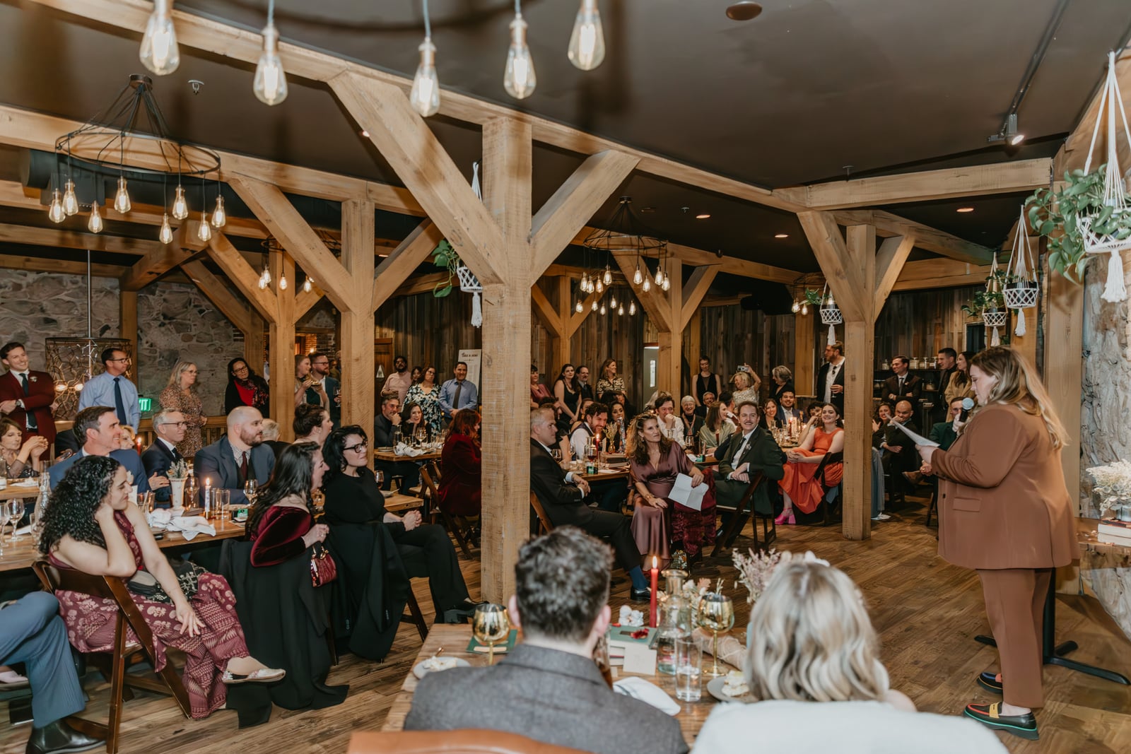 Evening wedding celebration in The Great Hall at Stone House Nevada City — historic stone interior