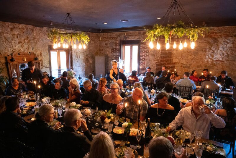 Evening cocktails in The Lounge at Stone House Nevada City — second-floor wedding-night gathering space