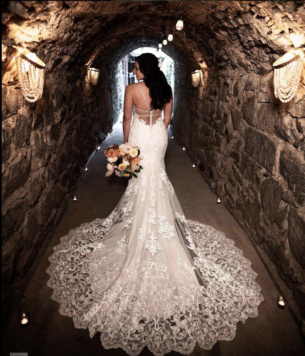 Real wedding celebration at Stone House Nevada City — couple's first dance in the candlelit reception hall surrounded by guests